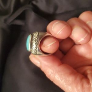 925 ring with turquoise center stone.  Size 5 & a half